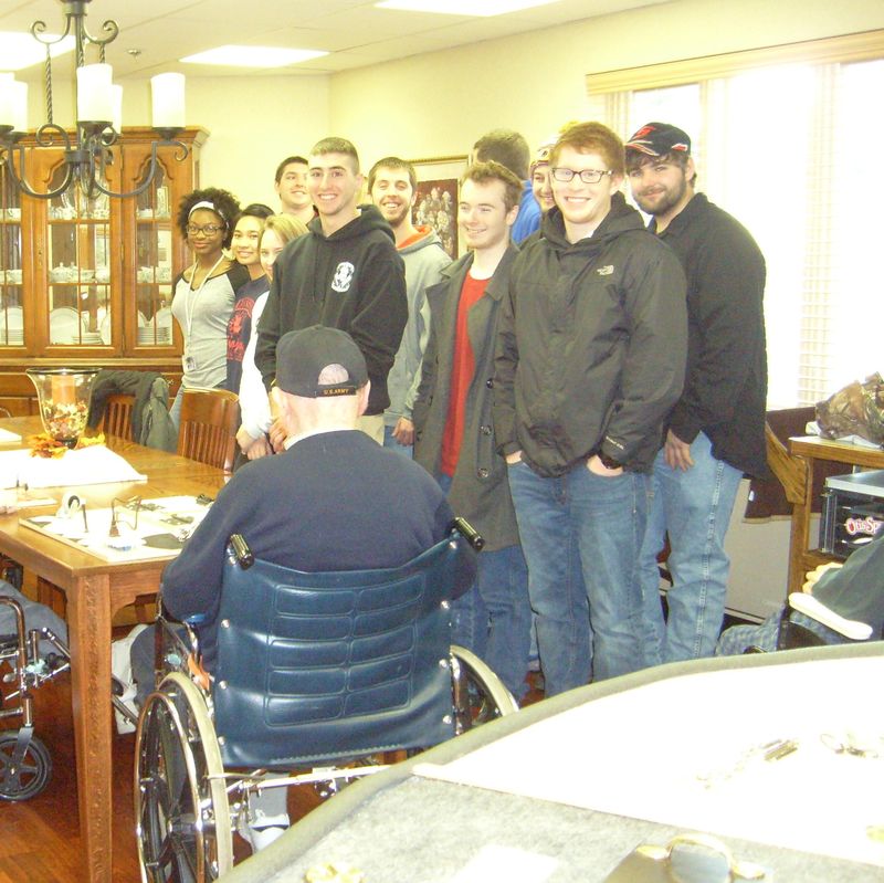 Students in the Introduction to Engineering Design class meet with the residence at Quincy Village to test the prototypes of their projects.