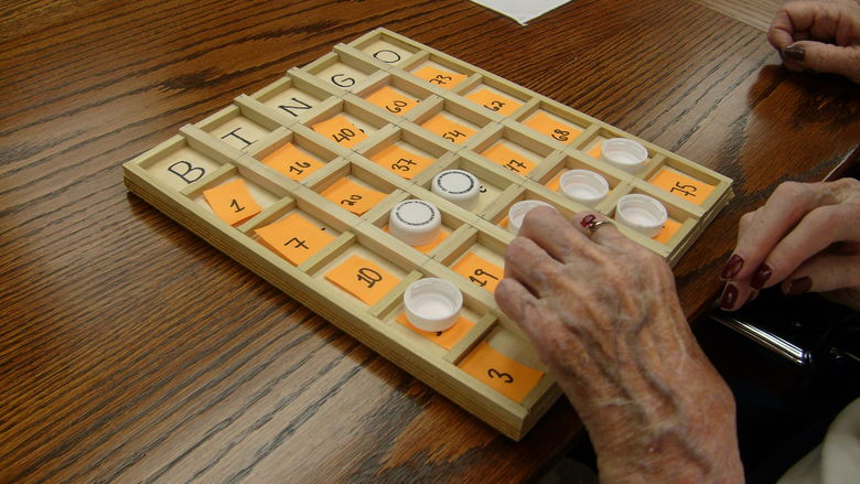 Ruby Hassey, a 103-year-old resident of Quincy Village, samples a prototype of a Bingo board.