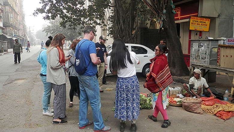 Students look over the items in a roadside grocery store in Kolkata.