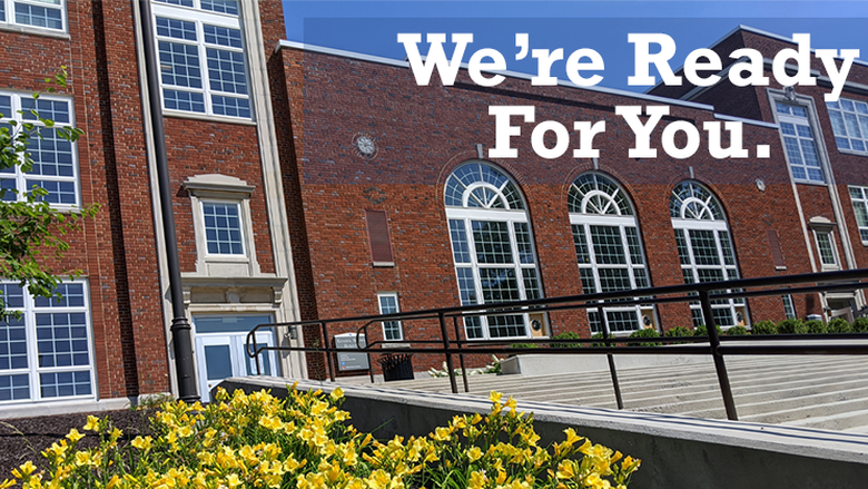 Brick campus building with text that reads "We're Ready For You." 