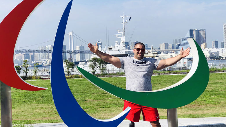 Jake standing in front of Paralympic sculpture in Tokyo 