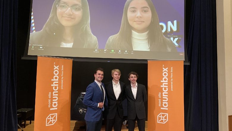 Winners of the 2023 LION Tank Pitch Competition stand and smile in front of Mont Alto Launchbox banners.