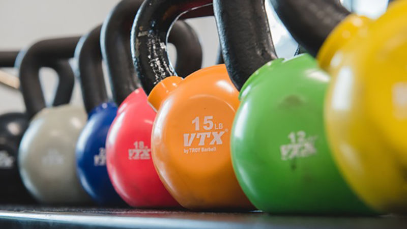 Kettlebells of many colors in a row