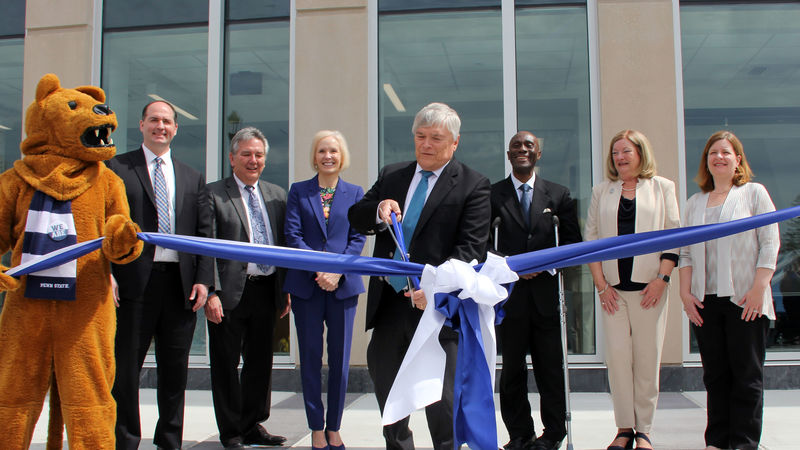President Barron, the Nittany Lion, and members of Penn State leadership cut the ribbon in front of the Allied Health Building. 