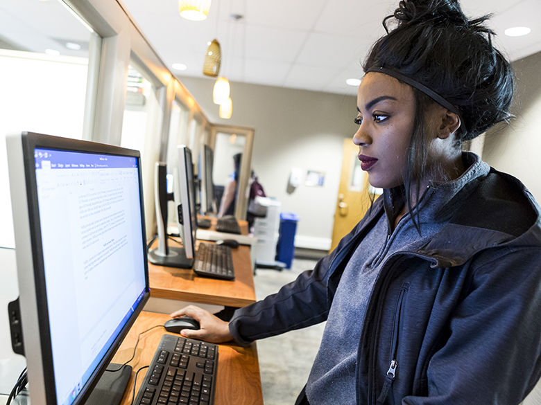 Female student works at computer station