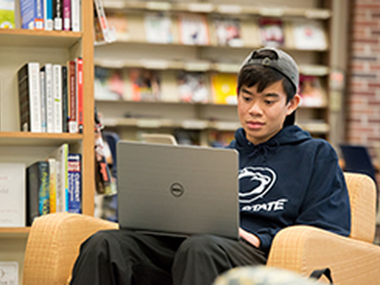 Student studies on laptop in Library