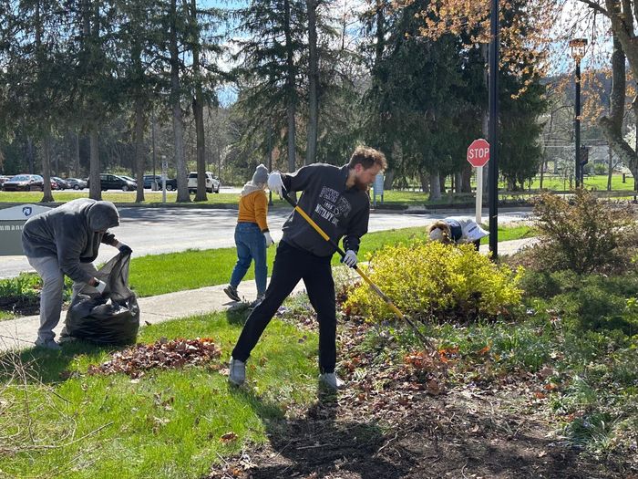 Students participating in Penn State Mont Alto's Day of Service work together in a garden.