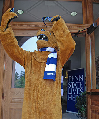 Nittany Lion mascot takes a selfie on the steps of Conklin Hall