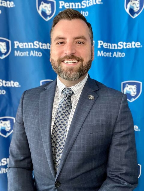 photo of Barrett Scroggs in front of a Penn State Mont Alto backdrop