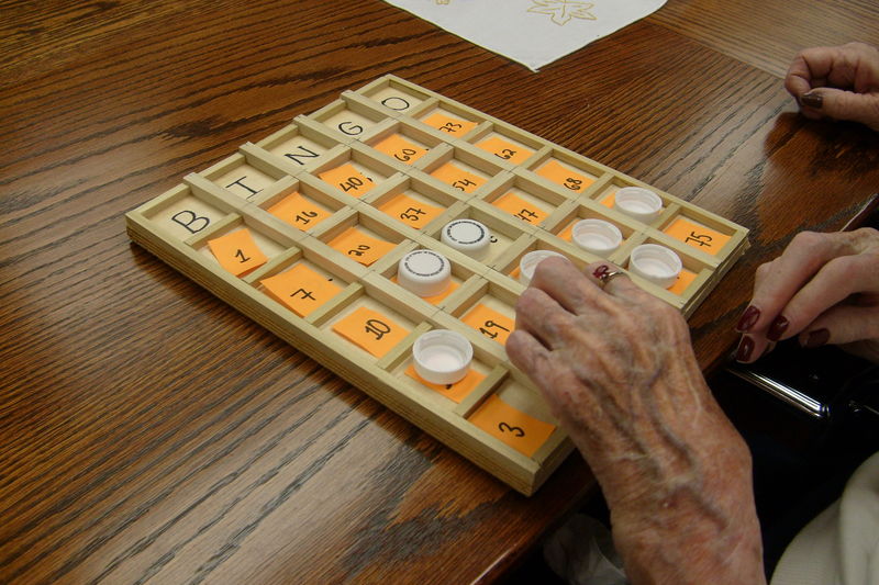 Ruby Hassey, a 103-year-old resident of Quincy Village, samples a prototype of a Bingo board.