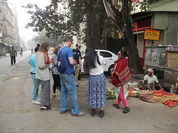 Students look over the items in a roadside grocery store in Kolkata.