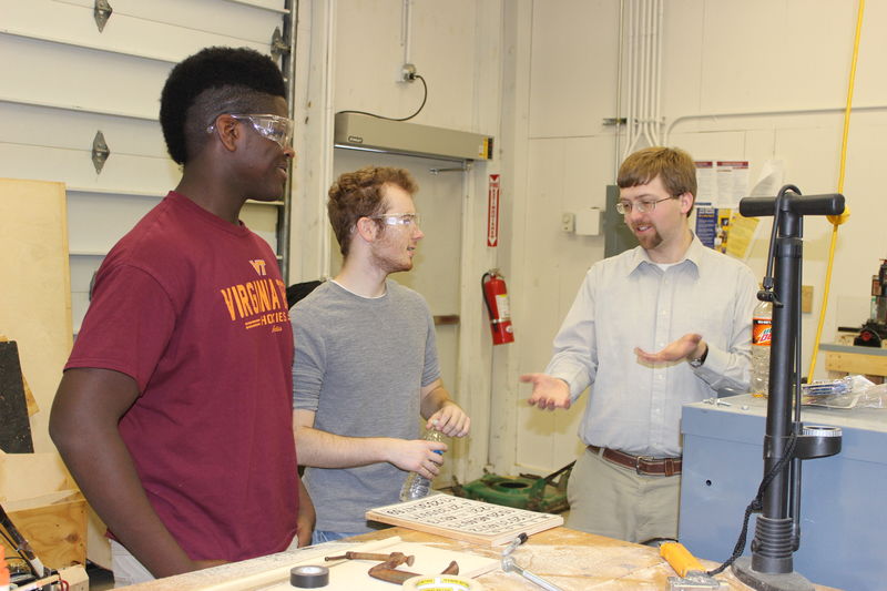 Engineering design students Aubrey Rowley and Chance Wagner receive advice from Dr. Jacob Moore, assistant professor of mechanical engineering.