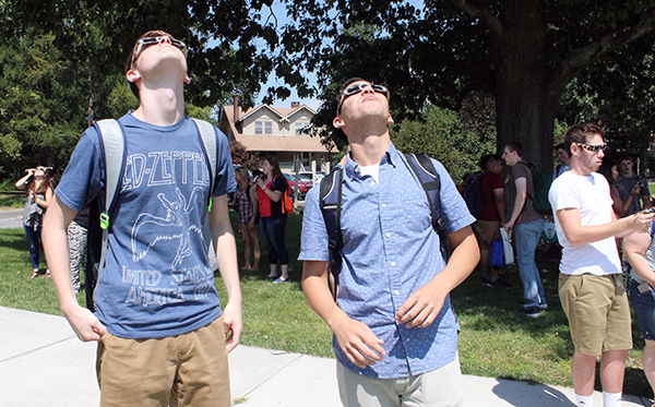 Freshmen Michael Fitch and Joshua Shinn watch the eclipse.