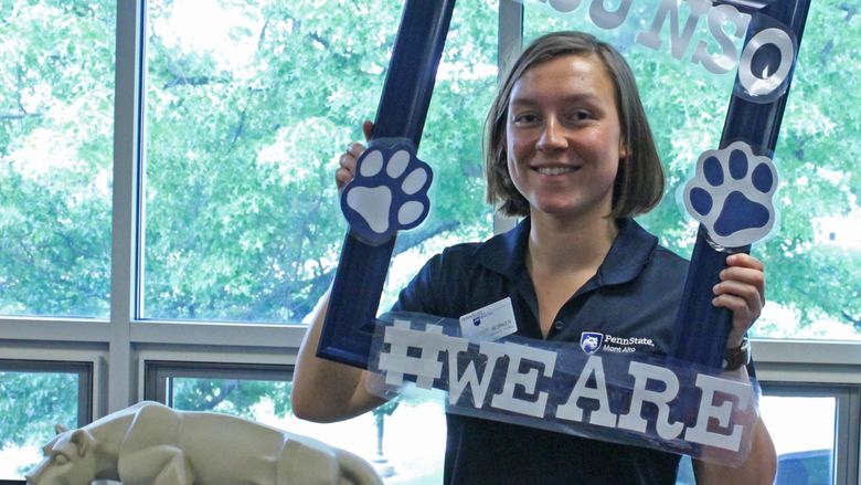 Penn State Mont Alto staff peeks through a frame at NSO