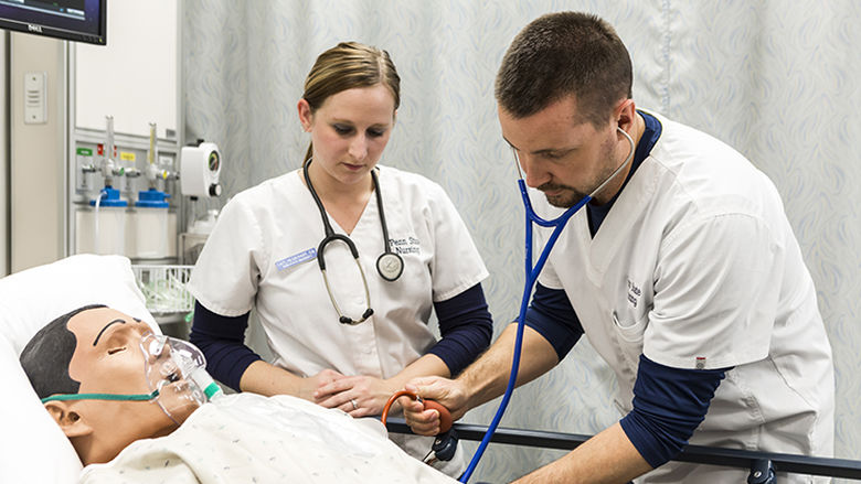 Nursing students practice techniques on high-tech simulator in lab