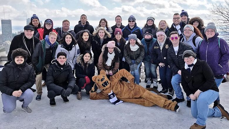 Group of Alternative Spring Break students pose with Nittany Lion in Montreal