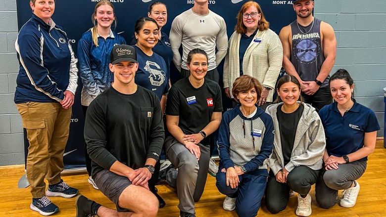 Group photo of faculty and students in front of Penn State Mont Alto athletics banner after the Functional Movement Screen.