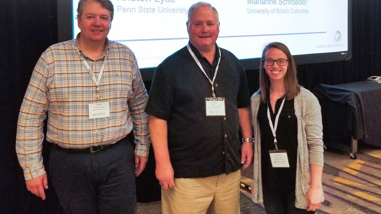 Penn State TLT Operations Team Award winners standing in front of a screen 