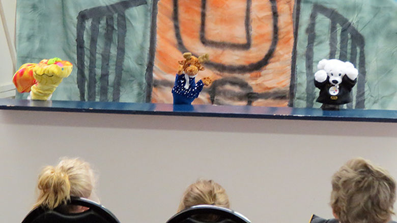 Theater students perform puppet show.