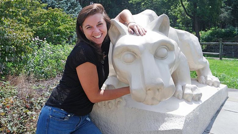 Courtney Stump poses with Lion Shrine at Penn State Mont Alto
