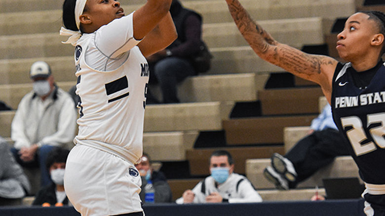 Female basketball player reaching for the ball 