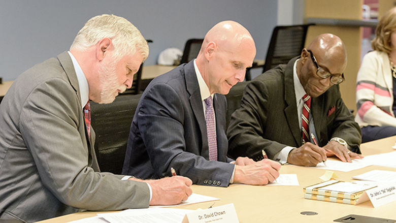 Drs. Chown, Sygielski, and Achampong sign articulation agreements.