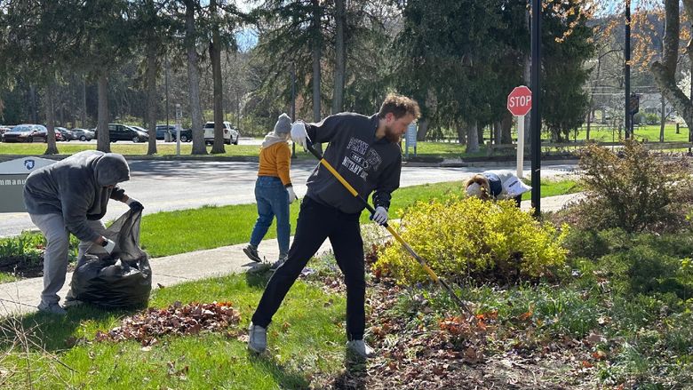Students participating in Penn State Mont Alto's Day of Service work together in a garden.
