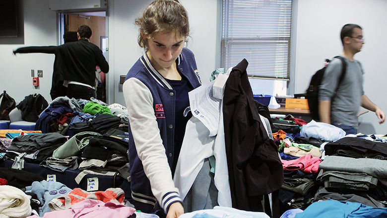 Female student selects professional clothing at Career Closet