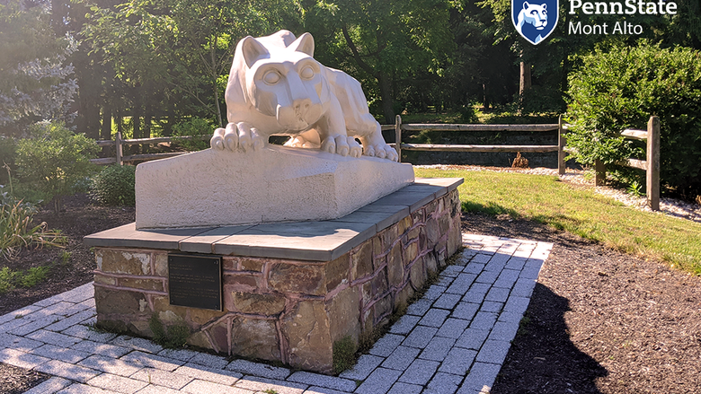 Sunny photo of shrine with Penn State Mont Alto logo