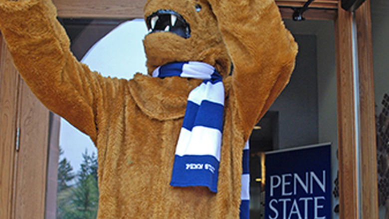 Nittany Lion mascot takes a selfie on the steps of Conklin Hall