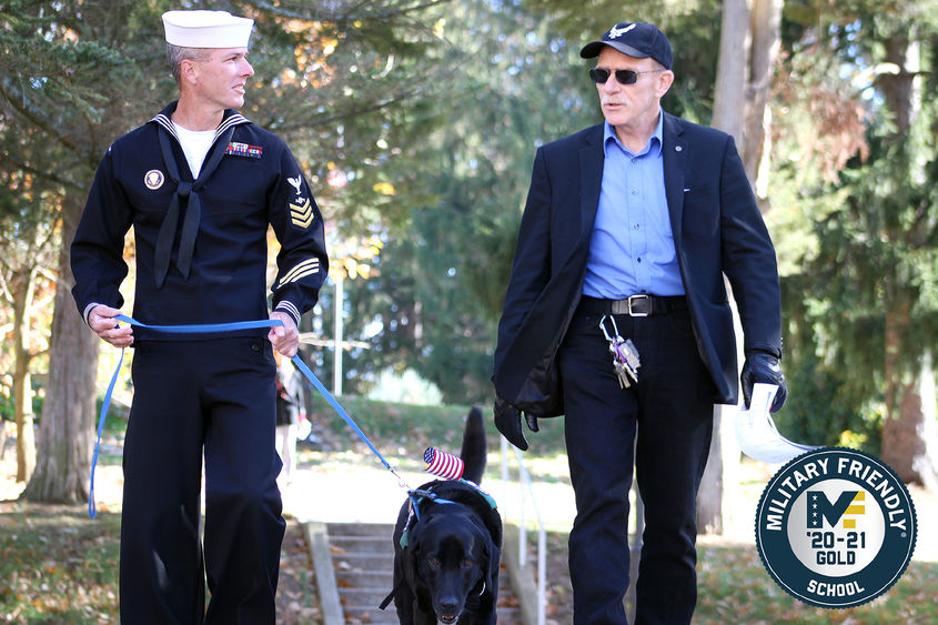 Student veteran John Wiesniewski and his service dog, Slate, cross campus with a veteran faculty member at Penn State Mont Alto.