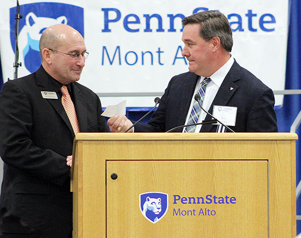 Randall Ackerman accepts check from Jim Ingram.