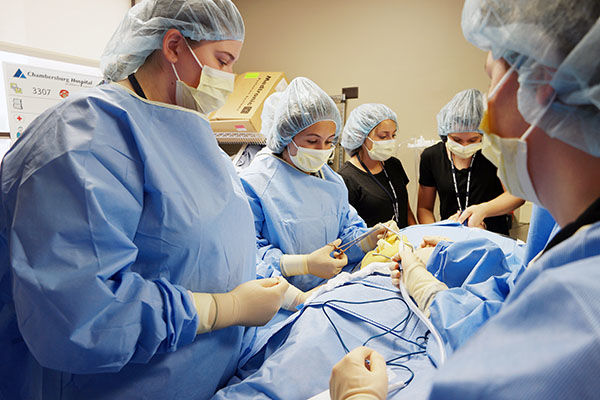Jordyn Hartsock (front, left) performs mock surgery at the Chambersburg Hospital. Jordyn Hartsock in MedCamp
