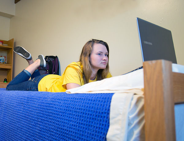 Student studying in her room. Student studying in her room.
