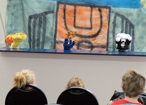 Theater students perform puppet show.