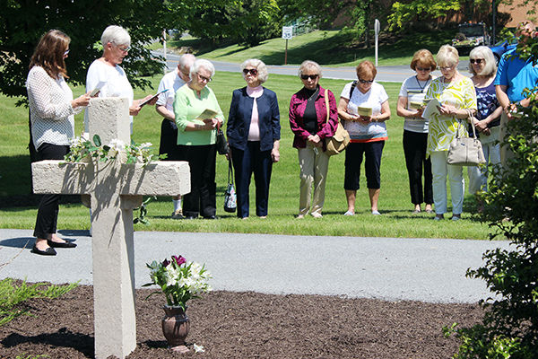 Questers read a poem entitled, "Emmanuel Chapel" following a ceremony to dedicate the renovated cross. Questers Read Poem