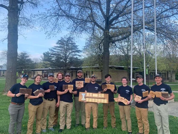 Members of the 2023 Woodsmen Team hold plaques after winning first place at the 2023 Mid-Atlantic Woodsmen's Meet