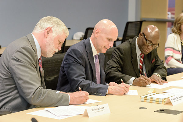 Drs. Chown, Sygielski, and Achampong sign articulation agreements.