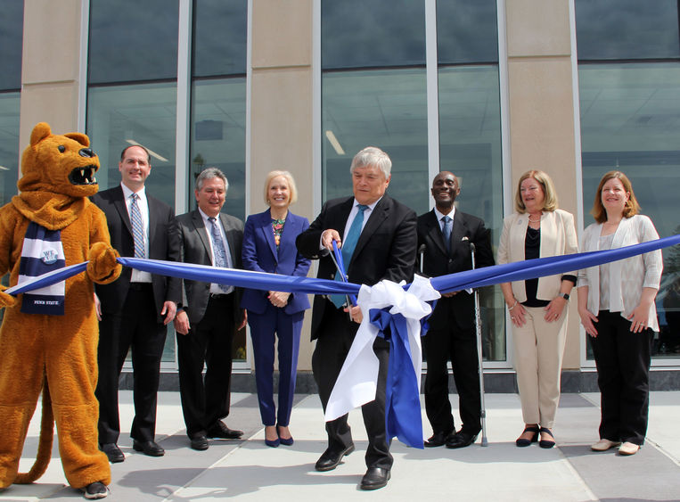 Individuals in front of Allied Health Building with mascot for ribbon cutting. 