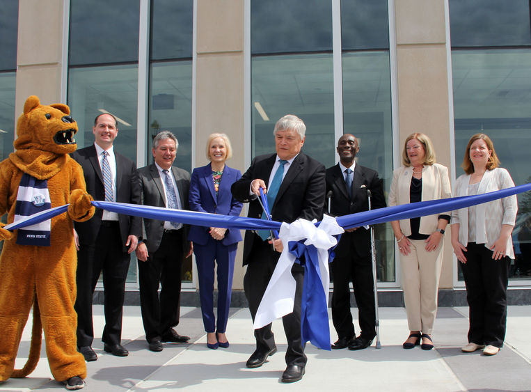Individuals in front of Allied Health Building with mascot for ribbon cutting.