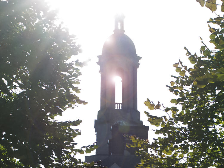 Sun streaming through Penn State's Old Main bell tower