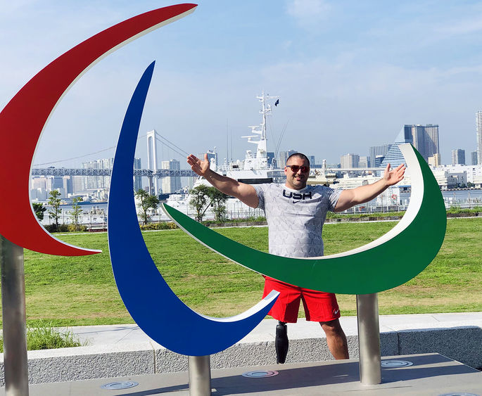 Jake standing in front of Paralympic sculpture in Tokyo 