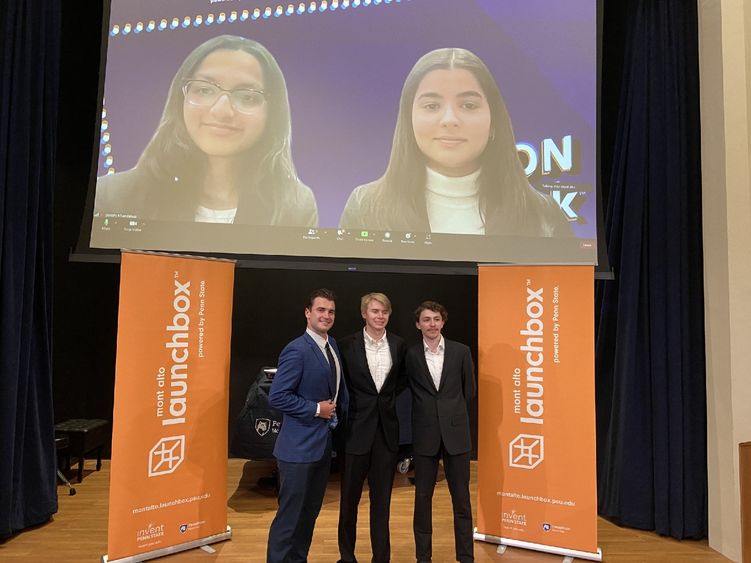 Winners of the 2023 LION Tank Pitch Competition stand and smile in front of Mont Alto Launchbox banners.